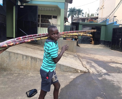 One of our street boys with donated sugar cane