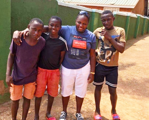 Three former street boys with Mary