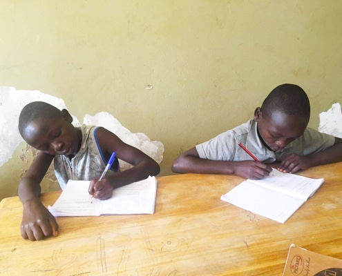 Two street children studying