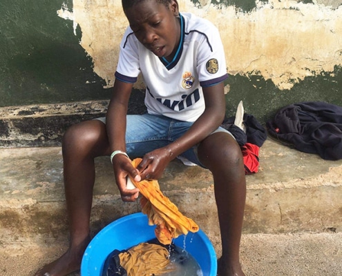 A street child washing clothes