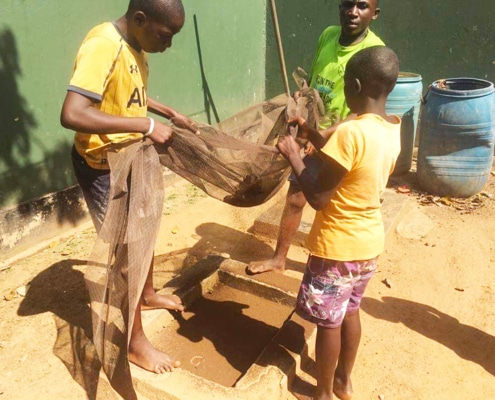 Street children sifting mud