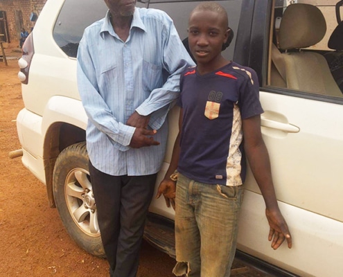 Former street child with his grandfather