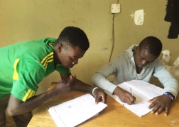 Two boys doing schoolwork