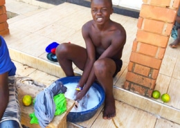 Former street child washing his clothes