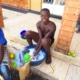 Former street child washing his clothes