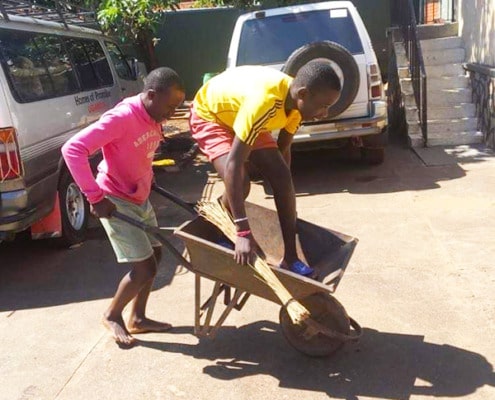 Street boys cleaning our compound