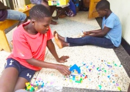 Street children enjoying Lego