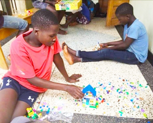 Street children enjoying Lego