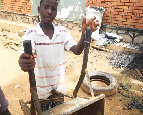 A former street child moving charcoal