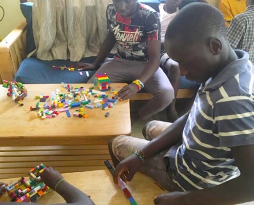 Boys playing with donated Lego