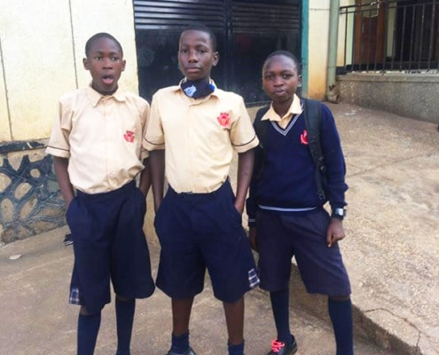 Three Homes of Promise boys returning from school