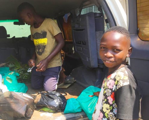 Joshua helping to unload the car