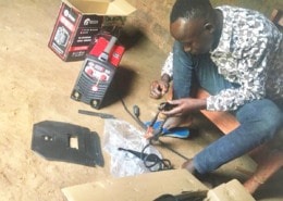 A former street boy setting up his tools