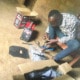 A former street boy setting up his tools