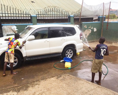 Street children cleaning the car