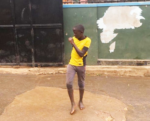 Street boy in Uganda playing football