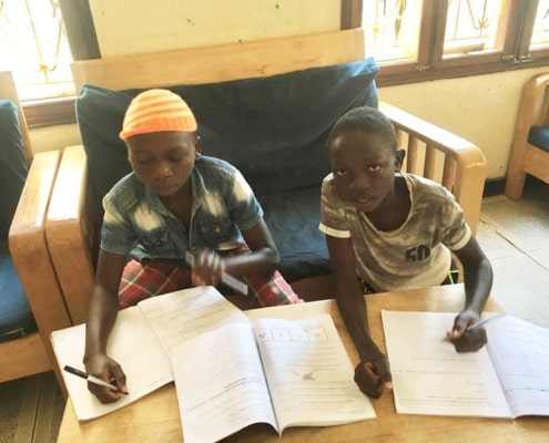 Two former street children studying hard