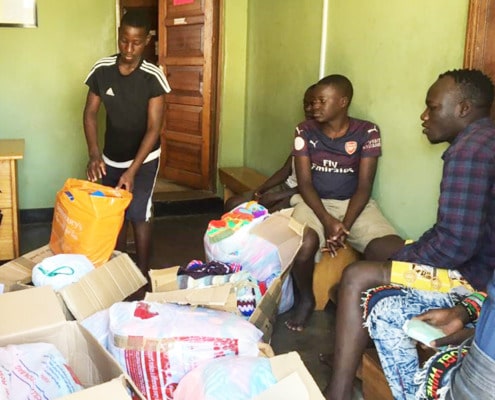 Boys at George's Place helping to unpack donations