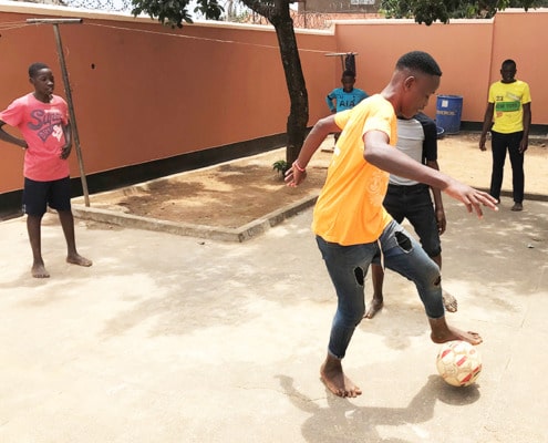 Boys playing football at the charity