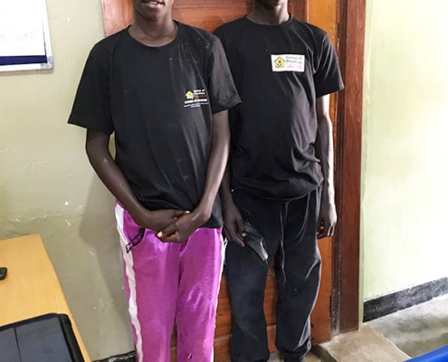 Two of our boys visiting a Ugandan clinic