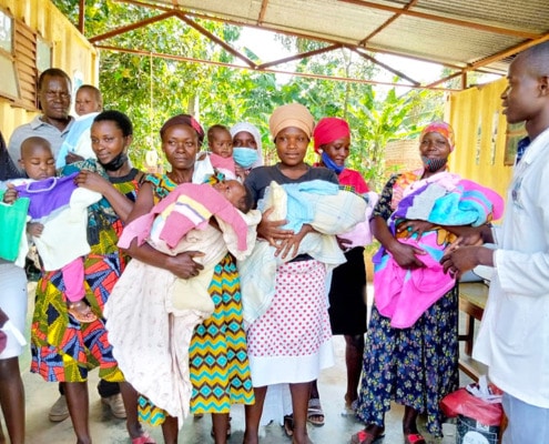 Donated fish and chip baby clothes in Uganda