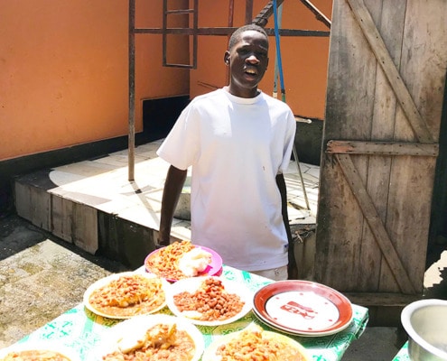 A former street child cooking