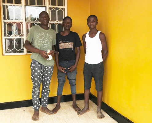 Three former street boys after decorating