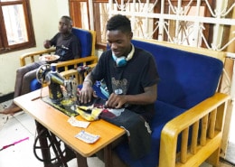 Former street child becoming a tailor