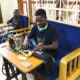 Former street child becoming a tailor
