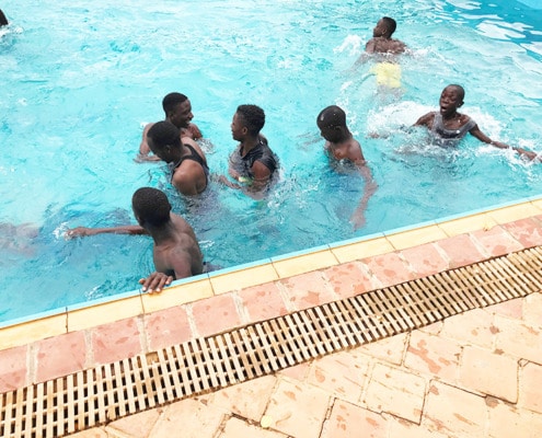 Former street boys in the swimming pool