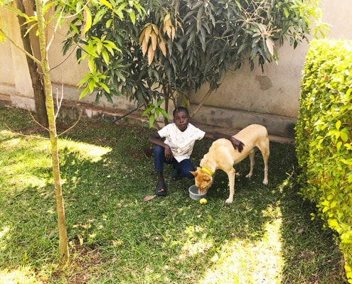 A former street boy with Jane's dog