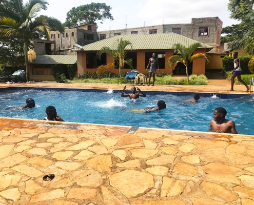 Former street children in the nearby pool