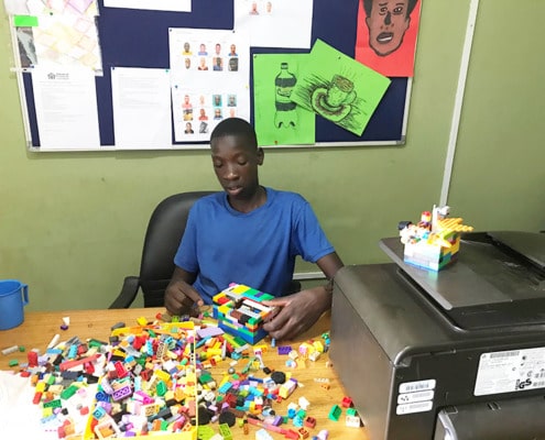 Former street child playing with Lego