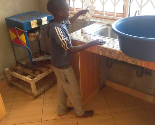 One of our newest boys washing the dishes