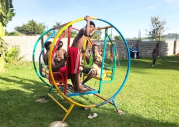 Former street children playing on the swings with Peanut