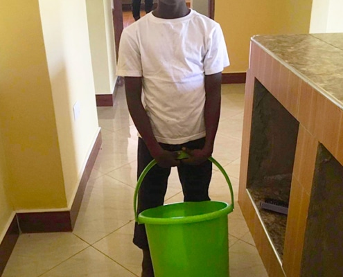 Former street child doing chores in the home