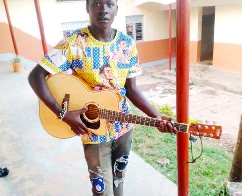 A former street boy now at college in Uganda