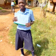 A former street child with his school report