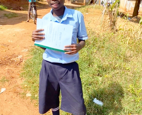 A former street child with his school report