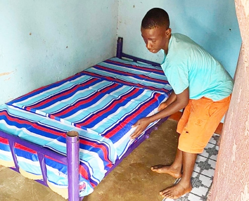Former street child making beds