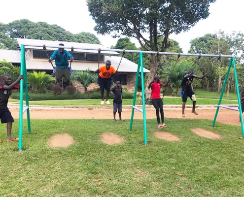 Our boys playing on the swings