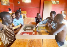Former street children playing Ludo