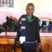 A former street child in clothes he has knitted himself