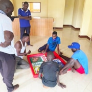 Boys playing their new Ludo game