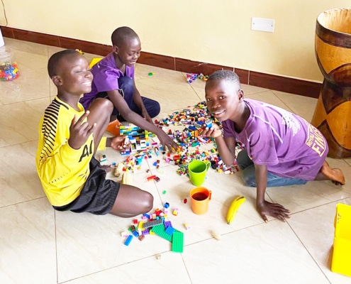 Former street children playing with Lego