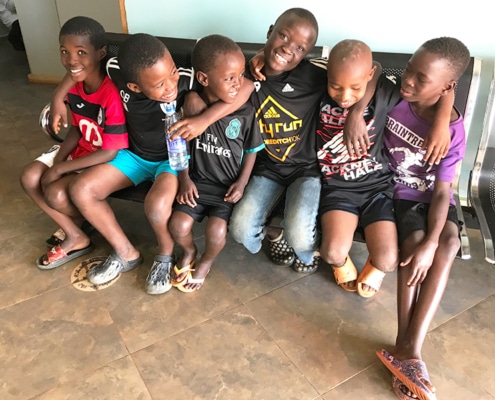 Four Congolese refugee boys with two from Homes of Promise
