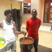 Two former street children cooking a meal