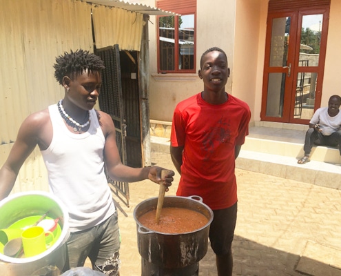 Two former street children cooking a meal