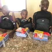 Three boys preparing for school in Uganda