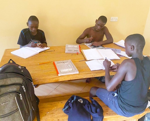 Former street children in Kampal doing their homework